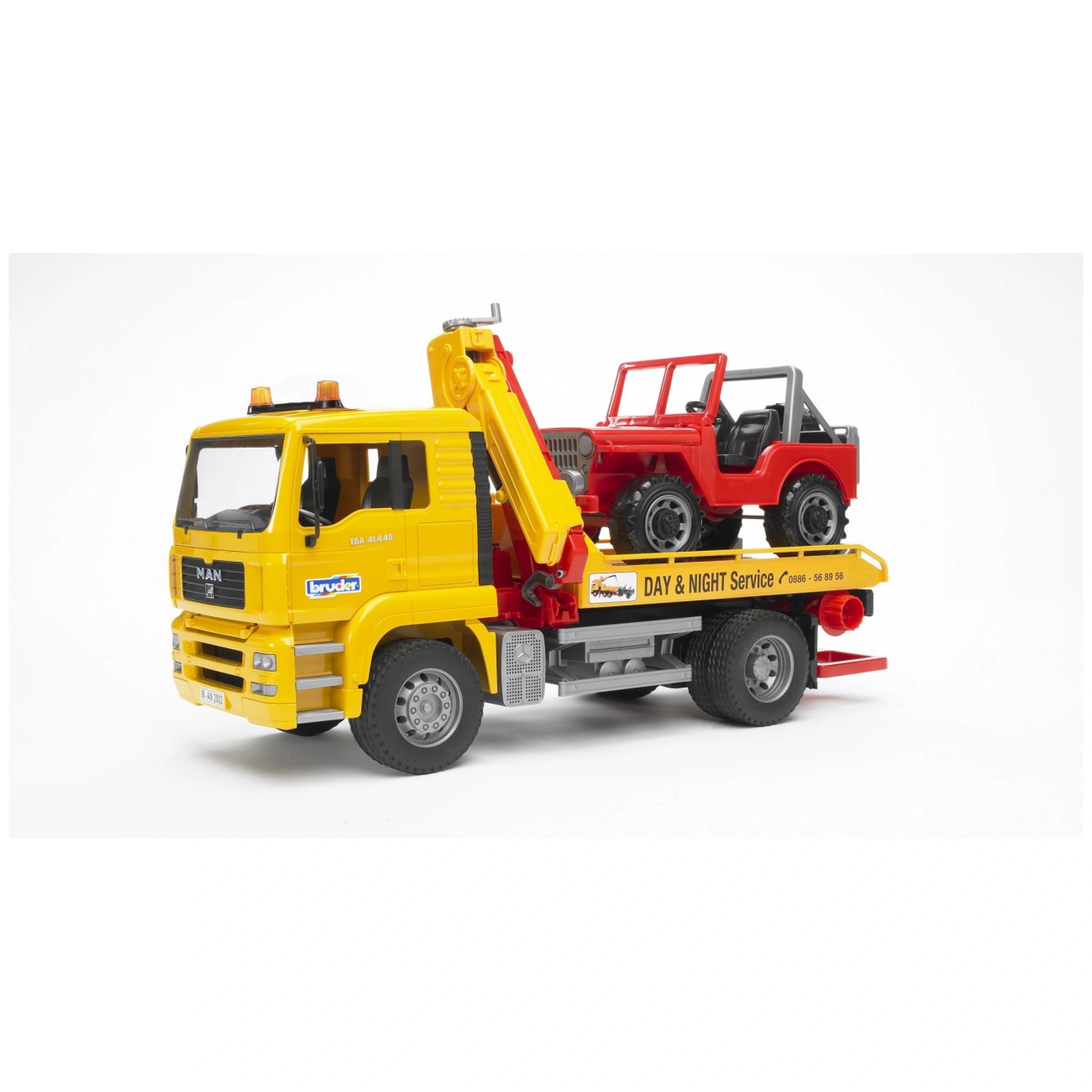 Yellow Bruder MAN TGA breakdown truck with extendable crane, carrying a red cross-country vehicle on its platform.