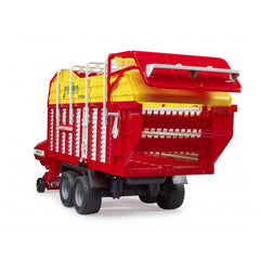 Red and yellow Bruder Pottinger Jumbo 6600 toy forage trailer with realistic details and functional parts.