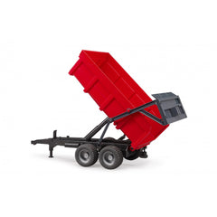 Red Bruder tipping trailer with automatic tailgate raised, featuring double axles and robust black frame.