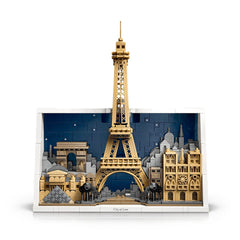 LEGO model of the Eiffel Tower surrounded by Parisian buildings, a bridge, and small figures, set against a blue sky.
