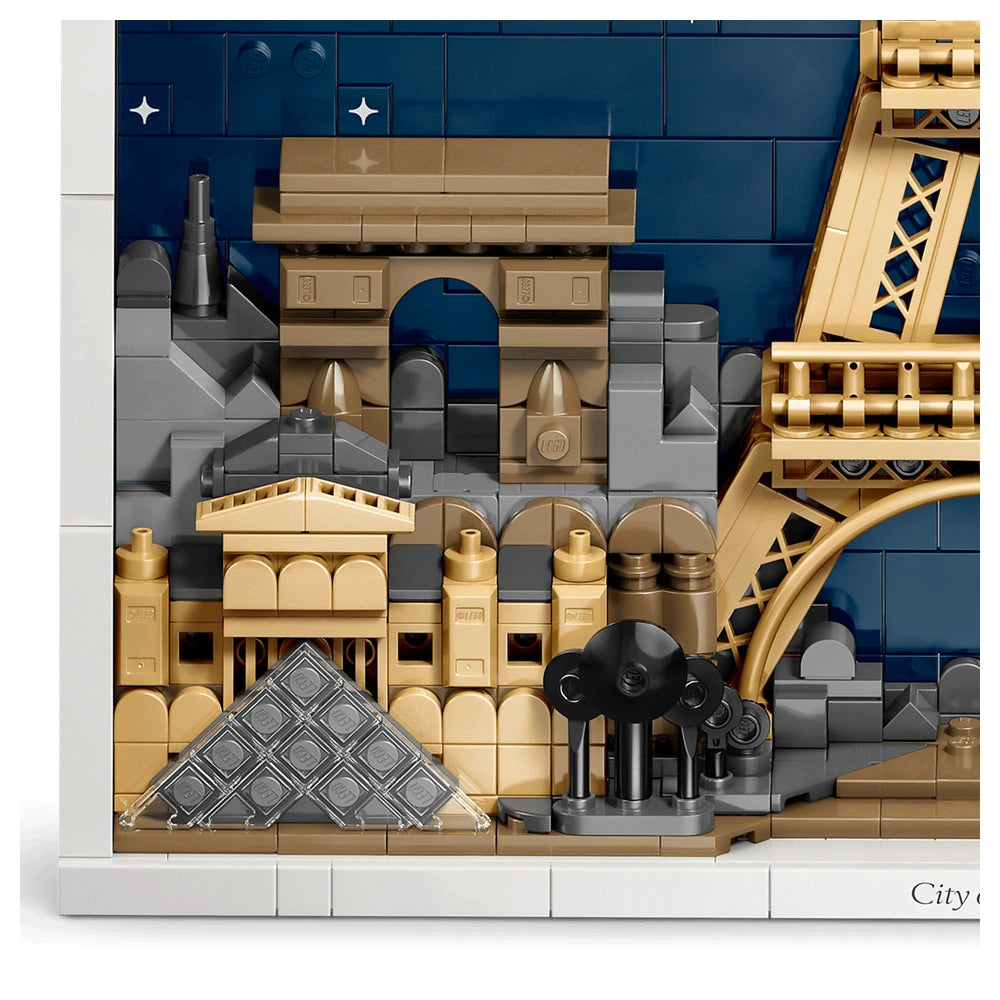 LEGO Architecture Paris model showcases a detailed cityscape with a bridge, tower, and house against a blue sky backdrop.