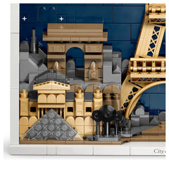 LEGO Architecture Paris model showcases a detailed cityscape with a bridge, tower, and house against a blue sky backdrop.