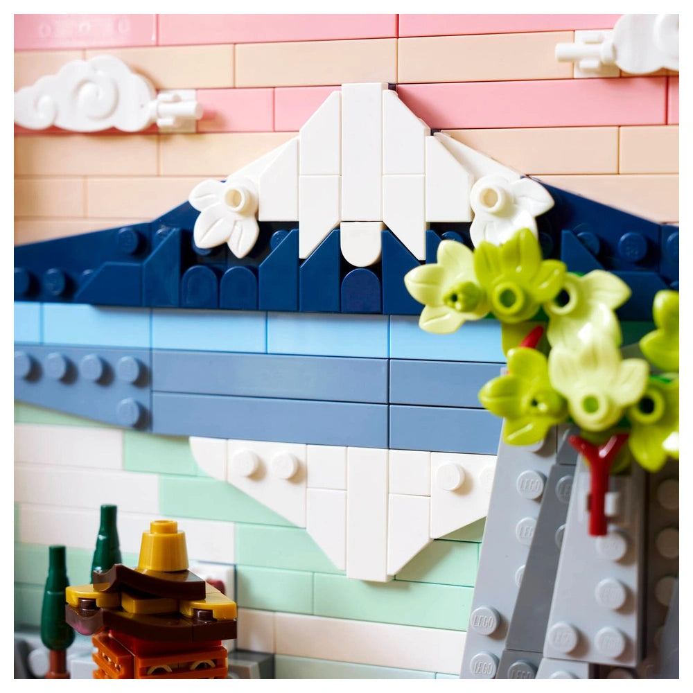 LEGO Art set features a colorful arrangement of bricks creating a stylized Japanese cherry blossom landscape on a baseplate.