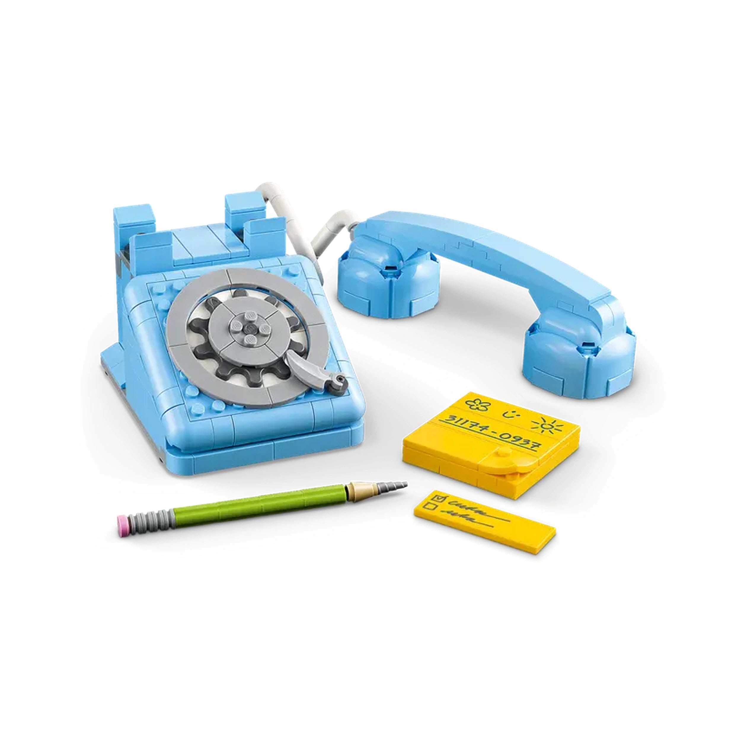 Retro blue LEGO telephone with a rotary dial and liftable receiver, accompanied by a green pencil and yellow notepads.