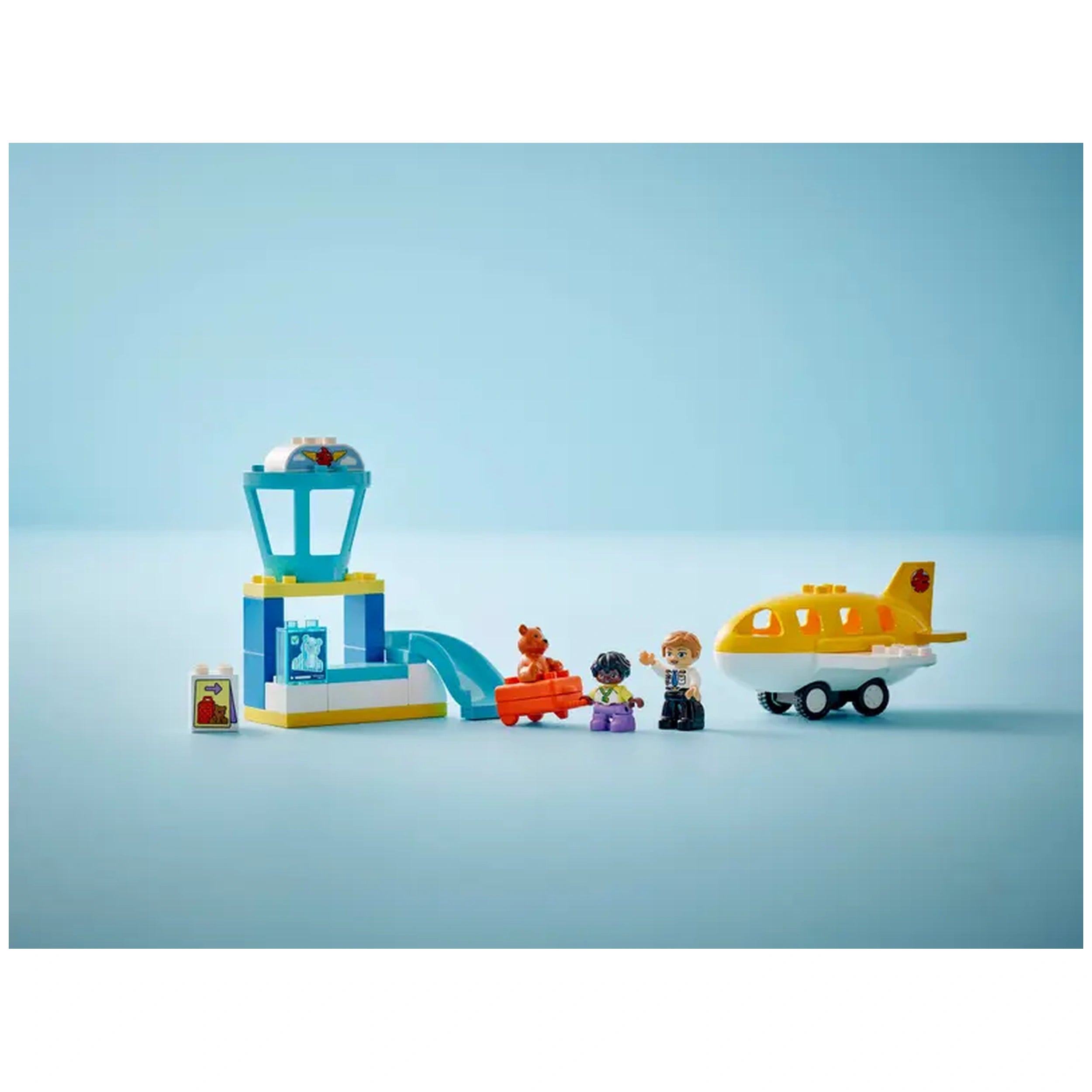 Colorful LEGO DUPLO airport set featuring an air traffic control tower, a yellow airplane, and three playful characters.