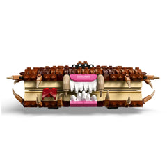 LEGO Harry Potter Chomping Monster Book of Monsters set features a brick-built monster book with a furry cover, large white teeth, and fangs, showcasing intricate details in brown, pink, and cream colors. The design includes playful eyes and jagged spikes, perfect for imaginative play and fans of the Harry Potter series.