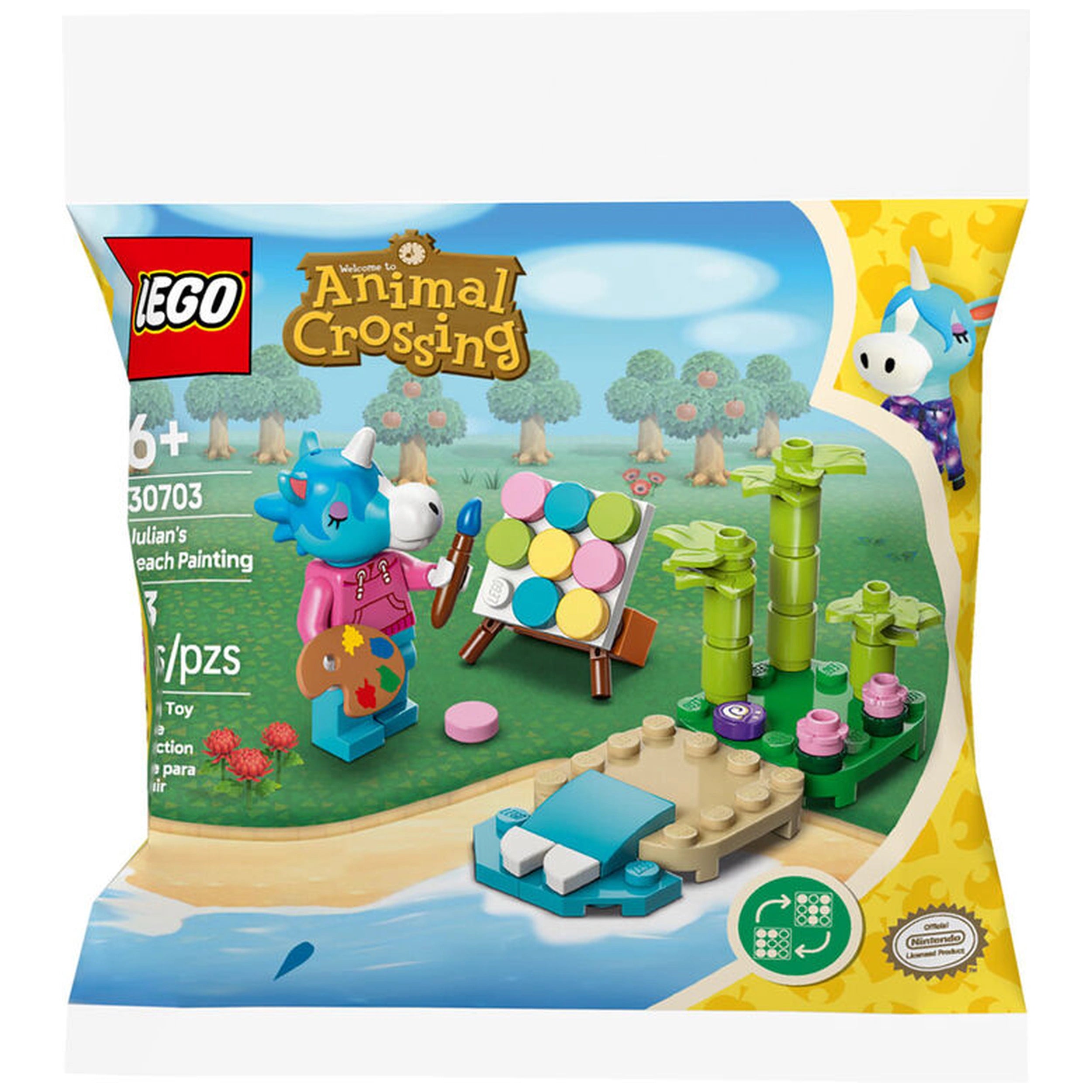 Lego Animal Crossing construction set featuring Julian painting on an easel with colorful tiles, surrounded by bamboo and a sandy beach.