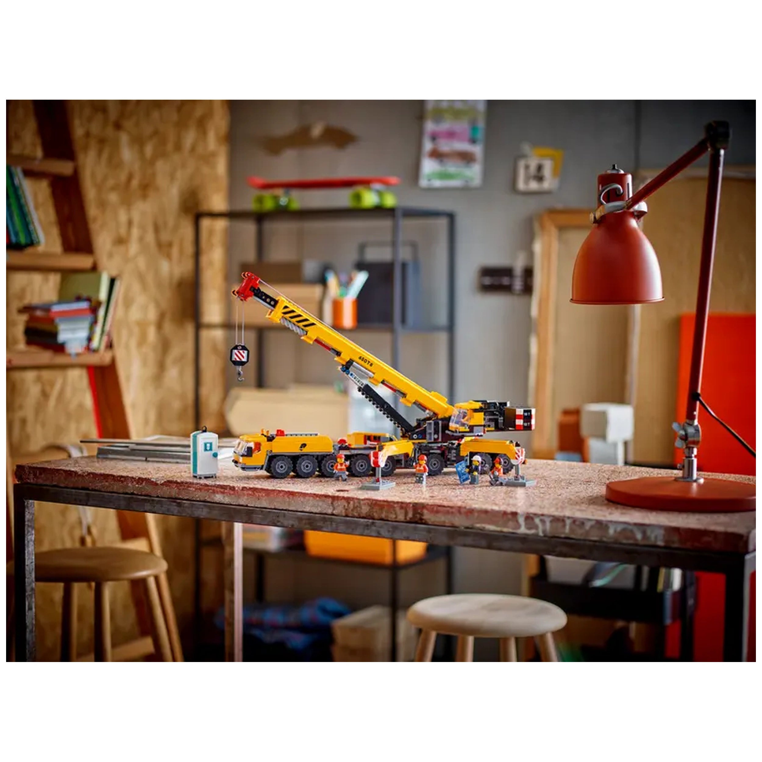 LEGO® City Mobile Construction Crane set displaying a detailed yellow crane on a table with various building crew minifigures and a portable toilet.