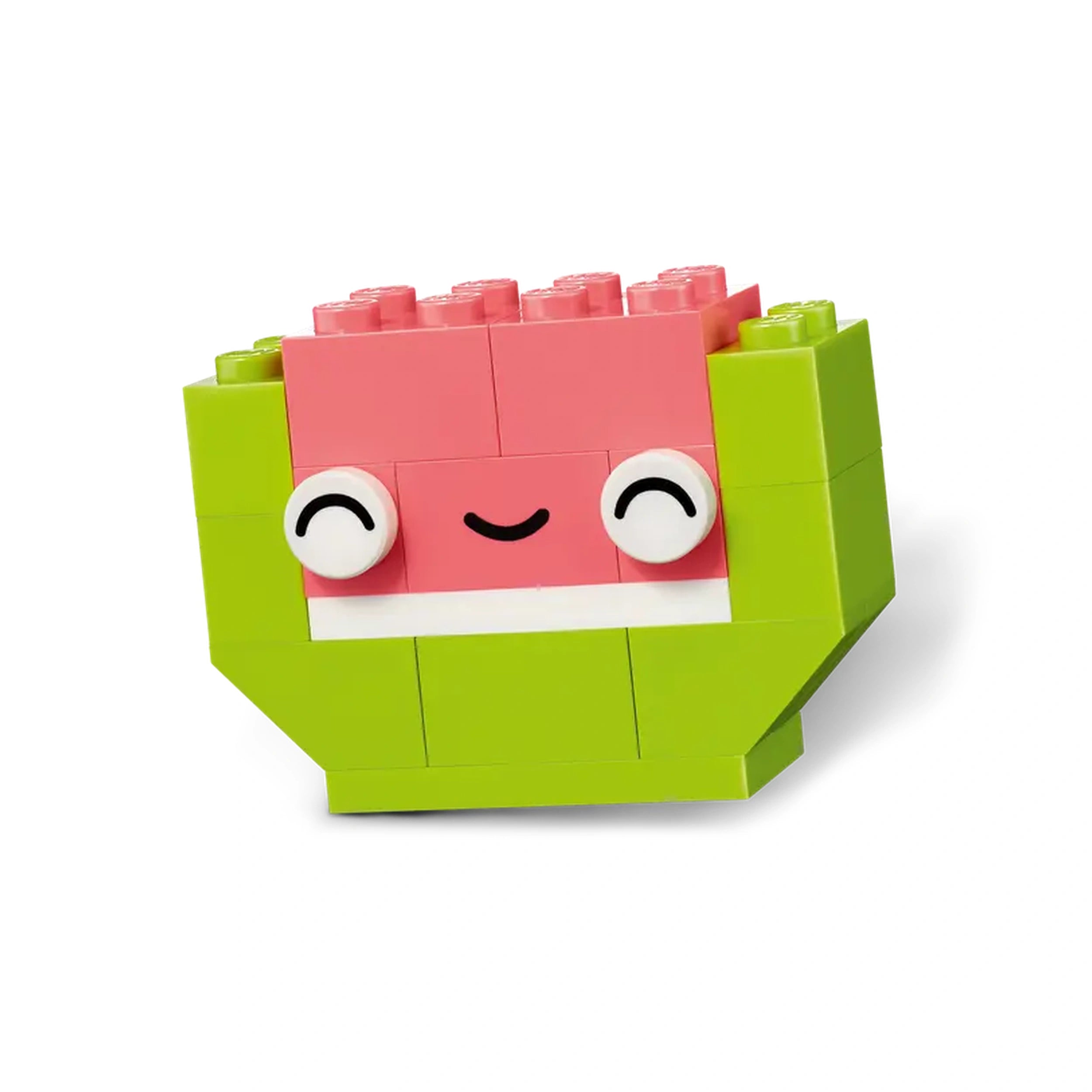 Brightly colored LEGO model of a smiling watermelon character with a pink top, green body, and cheerful eyes, designed for imaginative play.