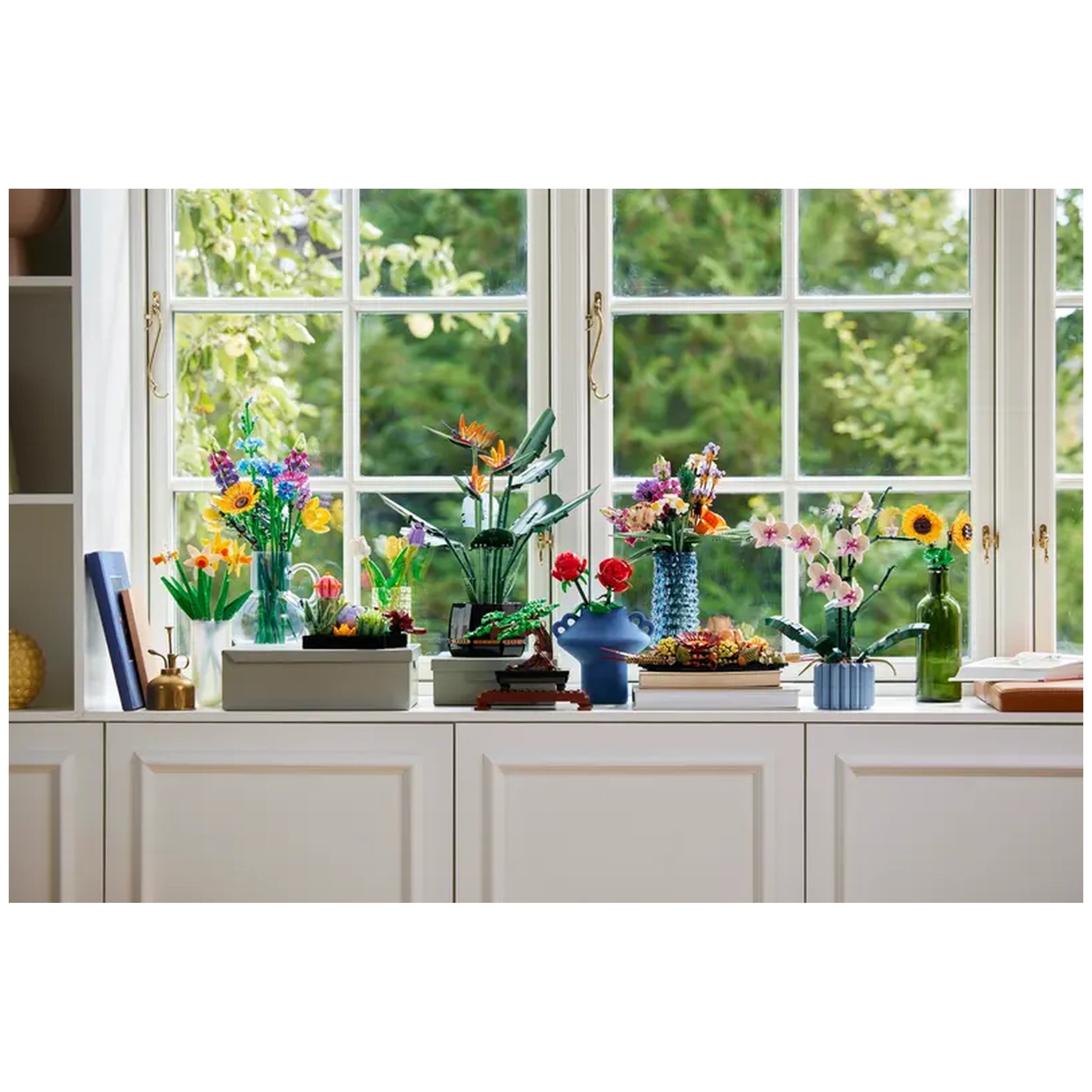 Colorful LEGO flower arrangements displayed on a windowsill, featuring sunflowers, orchids, and other blooms in various vases, brightening the space.