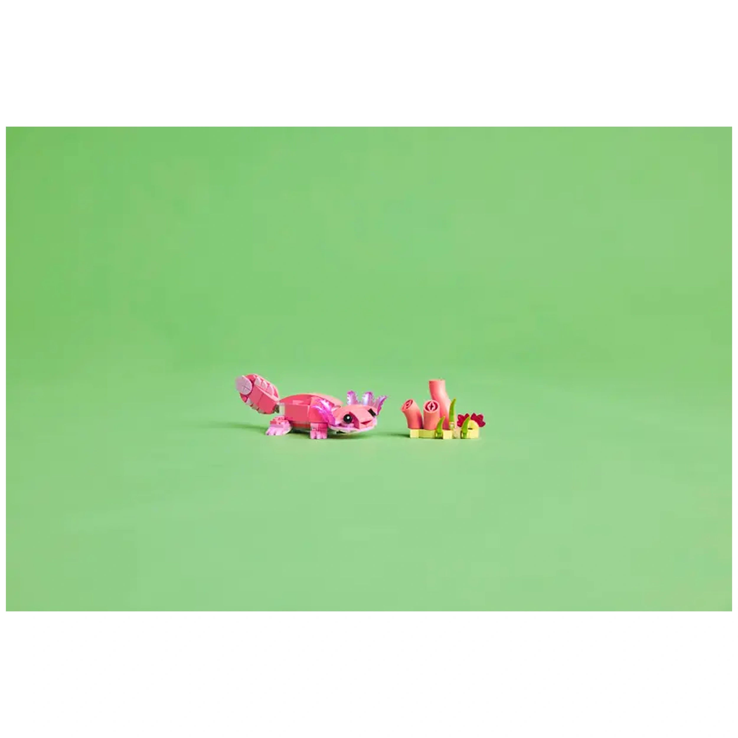 Pink LEGO construction set featuring a flamingo with a whimsical design, next to colorful plant elements against a green background.