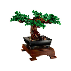 LEGO® Icons Bonsai Tree set featuring a lush green tree with intricately detailed leaves, placed in a black pot on a brown wooden stand.