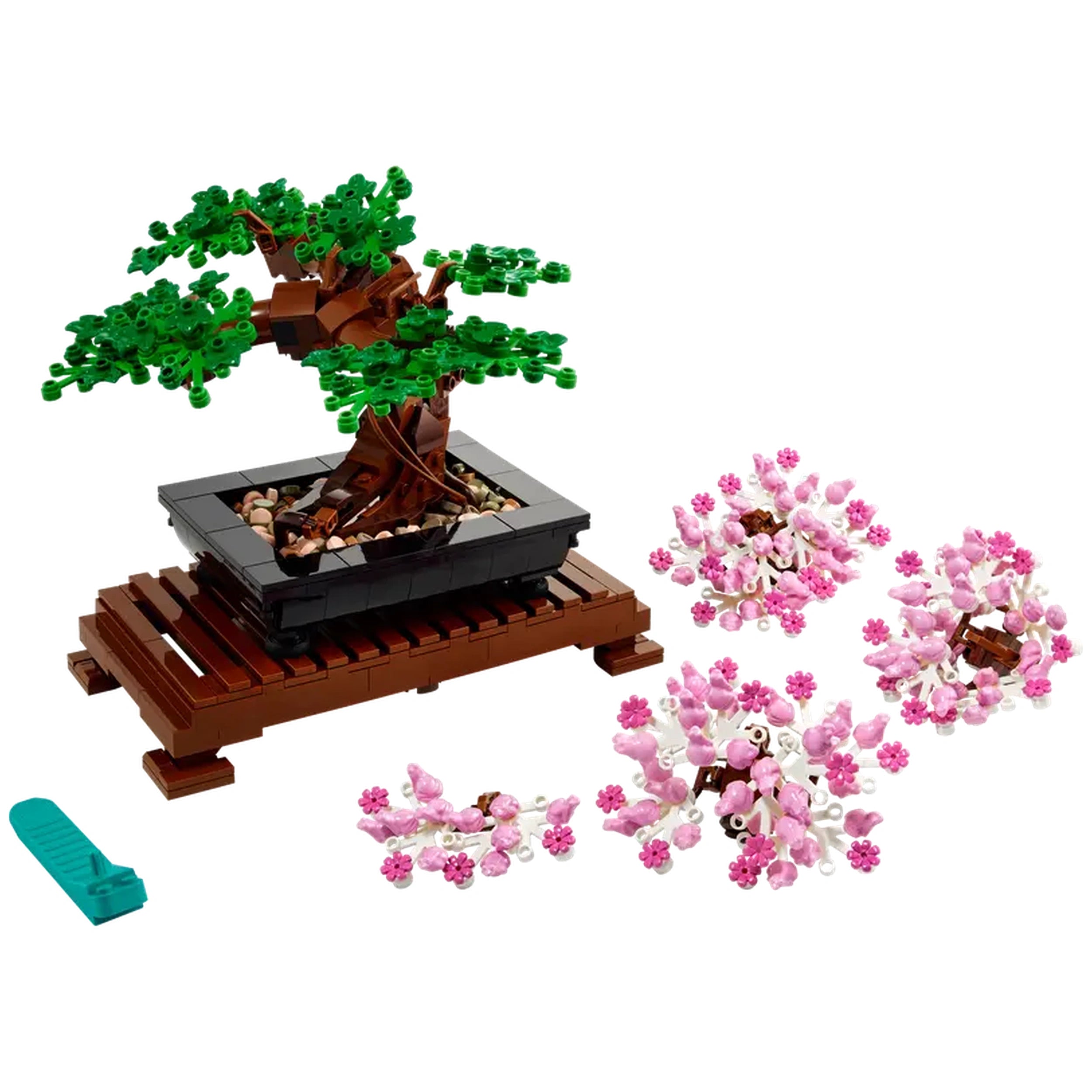 Lego Bonsai Tree construction set featuring a vibrant tree in a black pot on a wooden base, with pink cherry blossom parts scattered nearby.