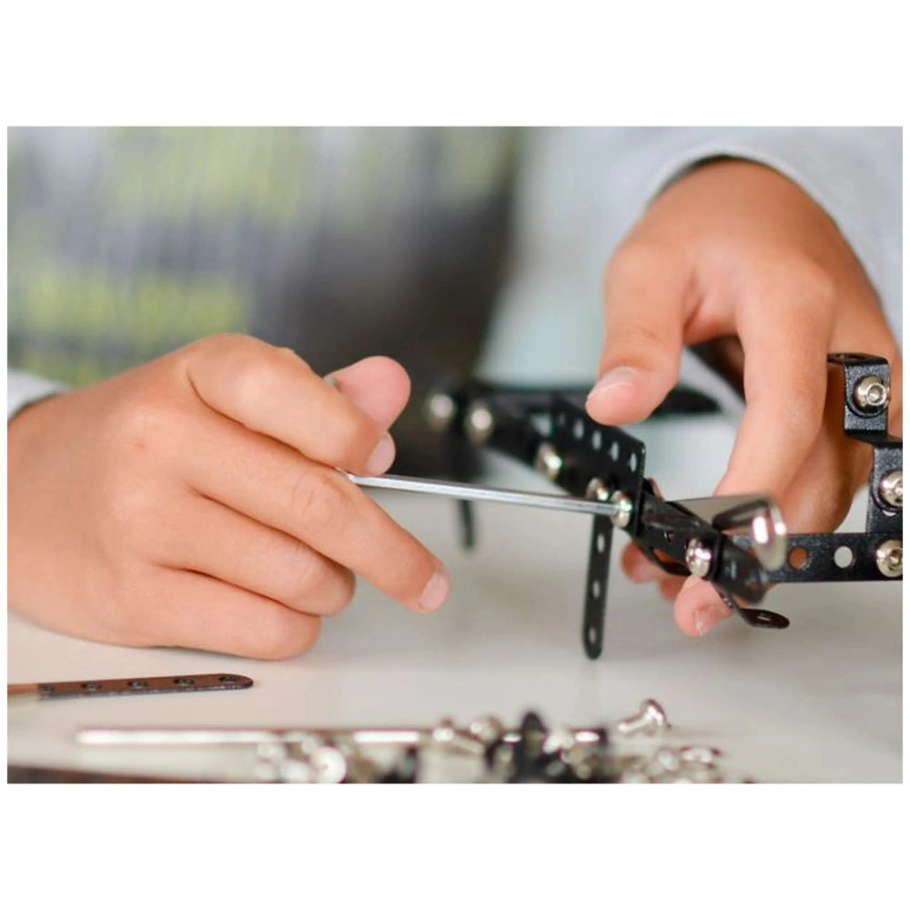 Child assembling Alexander Constructor Police Car set, tightening black metal pieces with a screwdriver.
