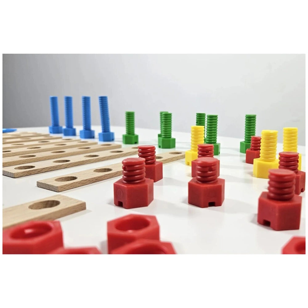 Colorful plastic screws and wooden boards from a kids' race car construction set, featuring red, yellow, green, and blue components.