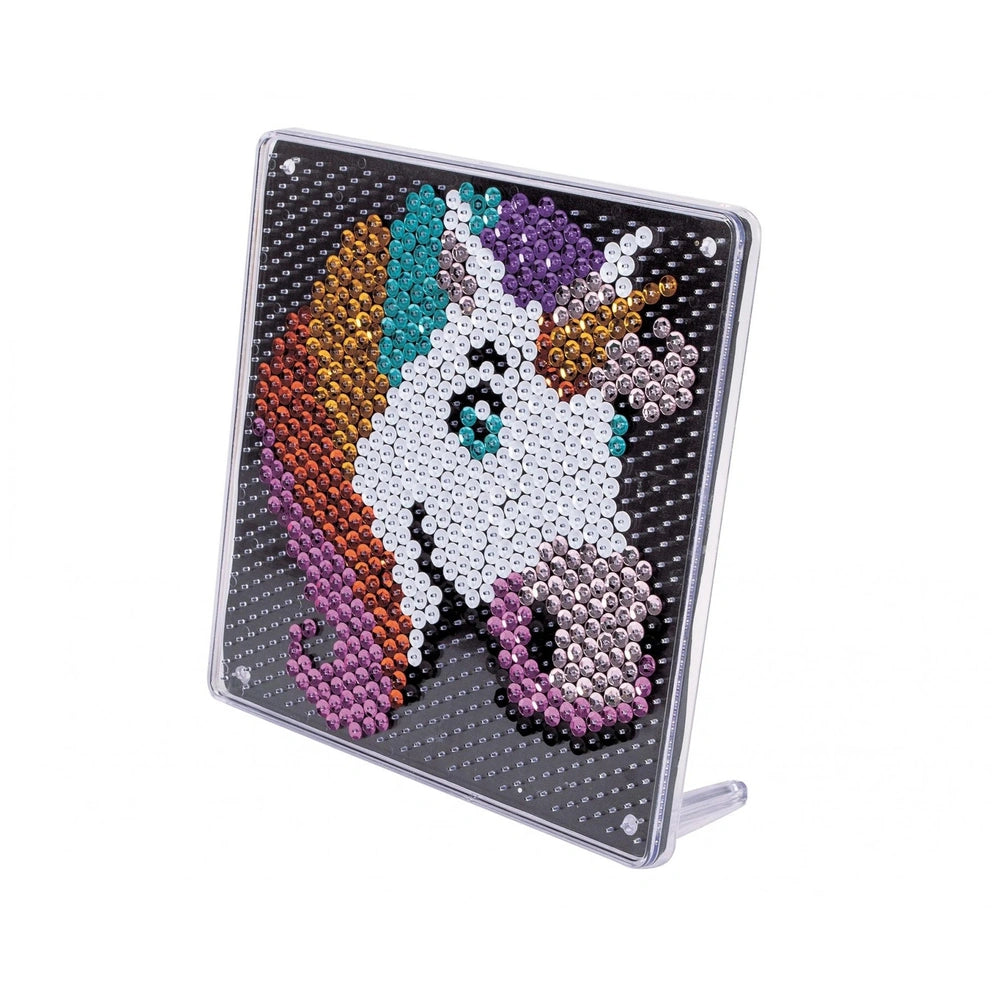 A colorful unicorn-themed sequin art activity featuring a shiny, textured surface with vibrant shades of purple, blue, orange