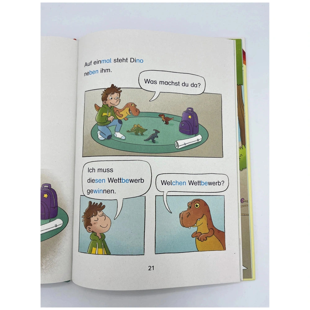 ARENA - Learning to Read book page shows a boy and dinosaur in a colorful adventure scene with speech bubbles in German.