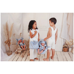ASI Dolls - Maxi Cosi With Neck Cushion: Two children play in a vintage-style room with a stroller and a dressed baby doll.