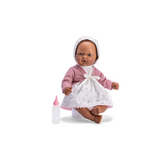 ASI Doll Oli, 30 cm, in white dress with stars, pink jacket, and matching bonnet, sitting next to a pink baby bottle.