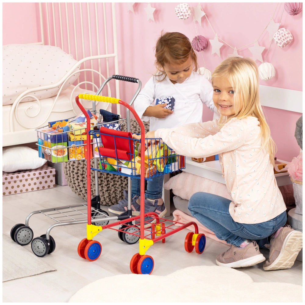 BAYER DESIGN shopping cart playset with food packages, featuring two girls holding colorful baskets in a pink room.