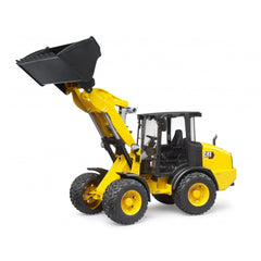 Yellow Bruder Cat Wheel Loader toy with raised black shovel, featuring articulated steering and detailed cabin on a white background.
