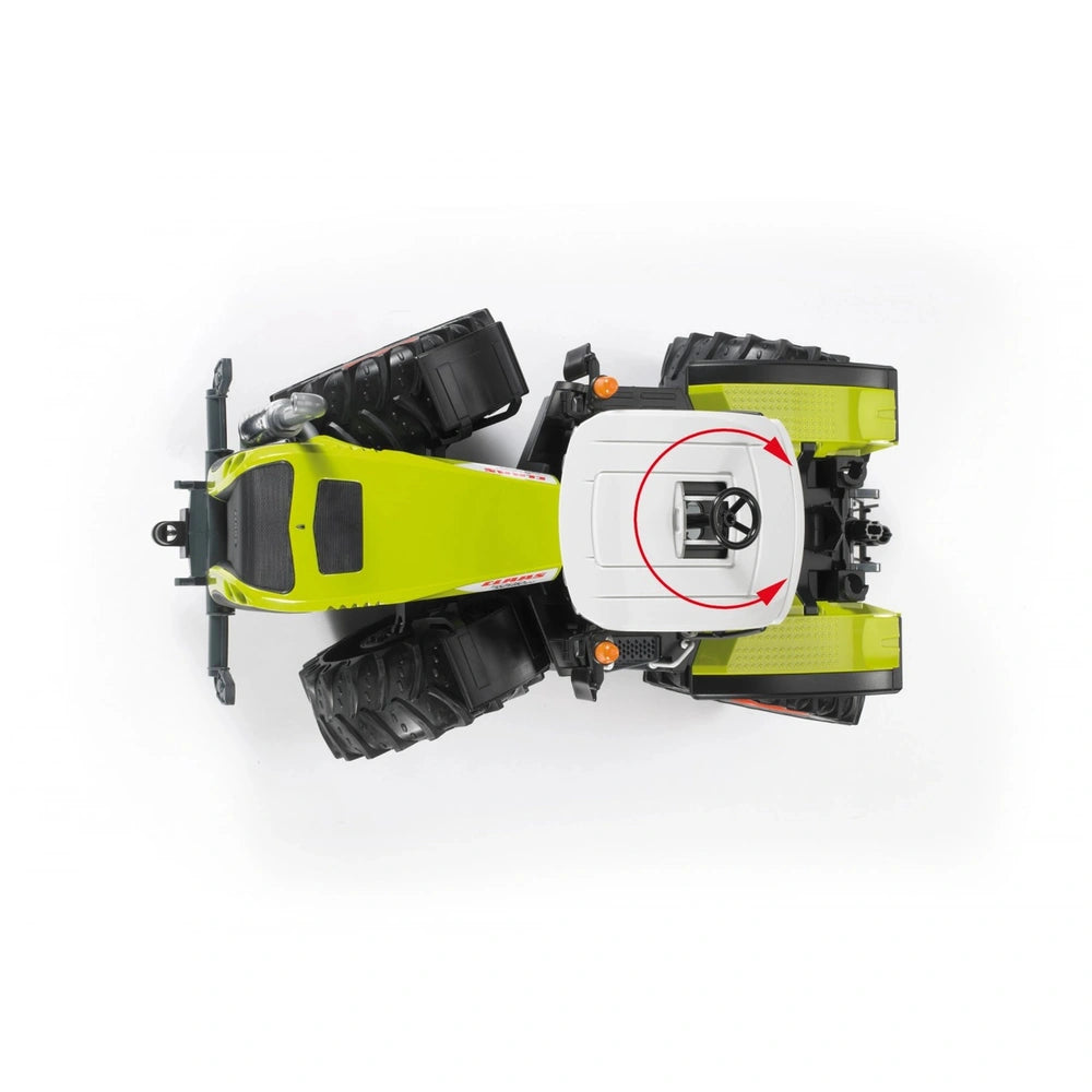 Top view of a Bruder Claas Xerion 5000 toy tractor in green and white, with large black tires and a rotating cab.