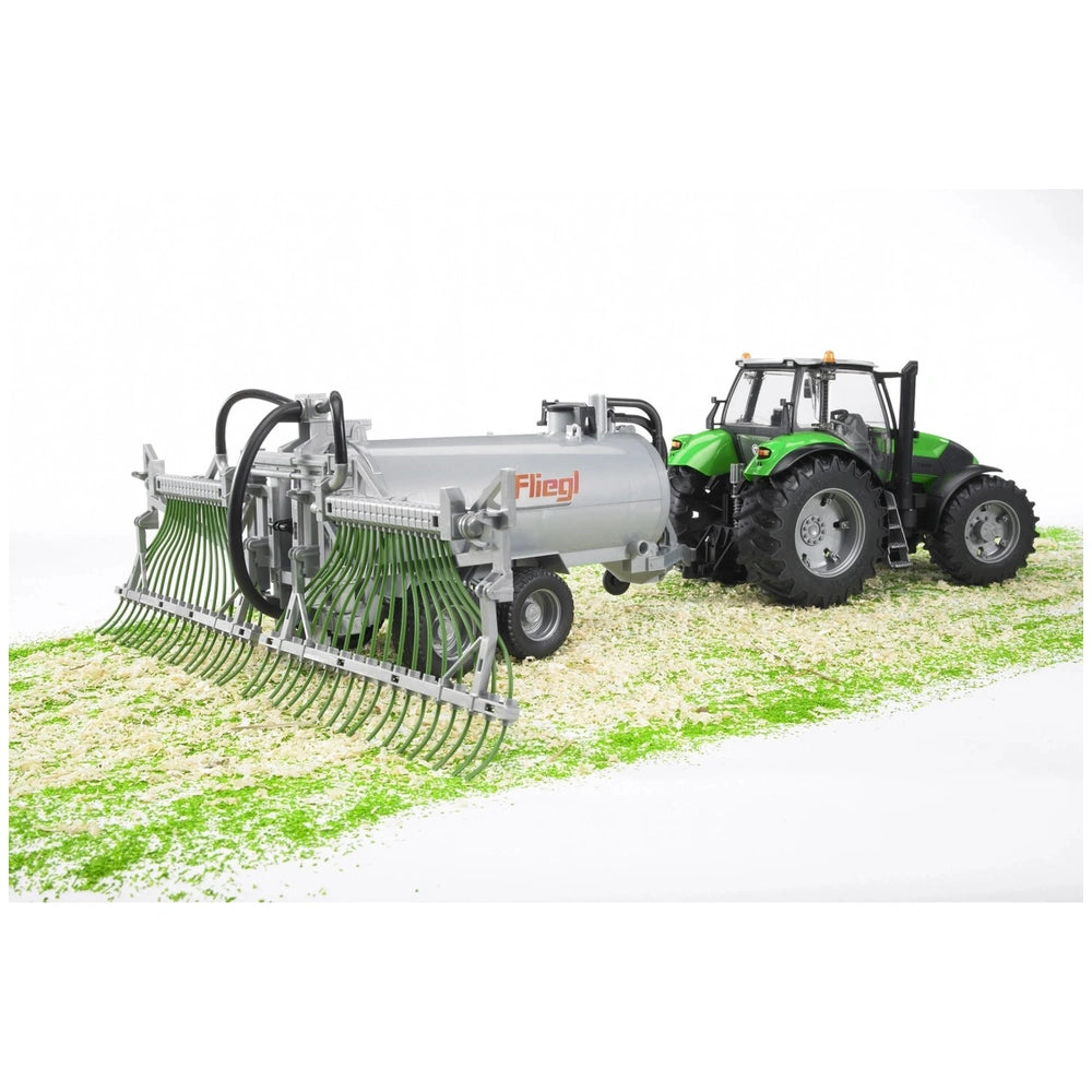 Bruder Fliegl Barrel Trailer with green tractor on textured surface, featuring realistic details and spread tubes.