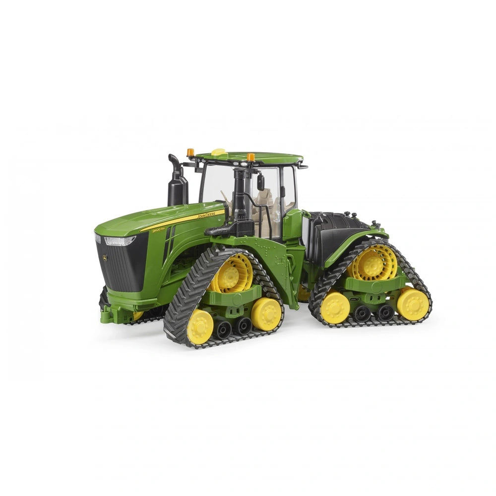 Green and yellow John Deere 9620RX toy tractor with track belts, showcasing realistic details and articulated steering.