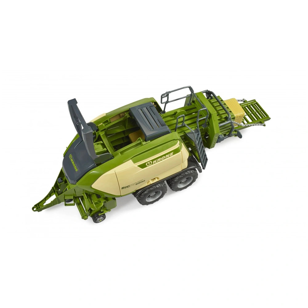 Bruder Krone Big Pack 1290HDP toy baler with green and beige body, foldable pick-up, and two hay bales.