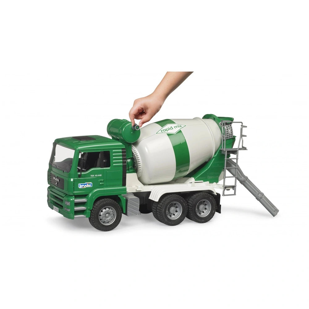 Child's hand turning the mixer drum of a green Bruder MAN TGA cement mixer toy truck.