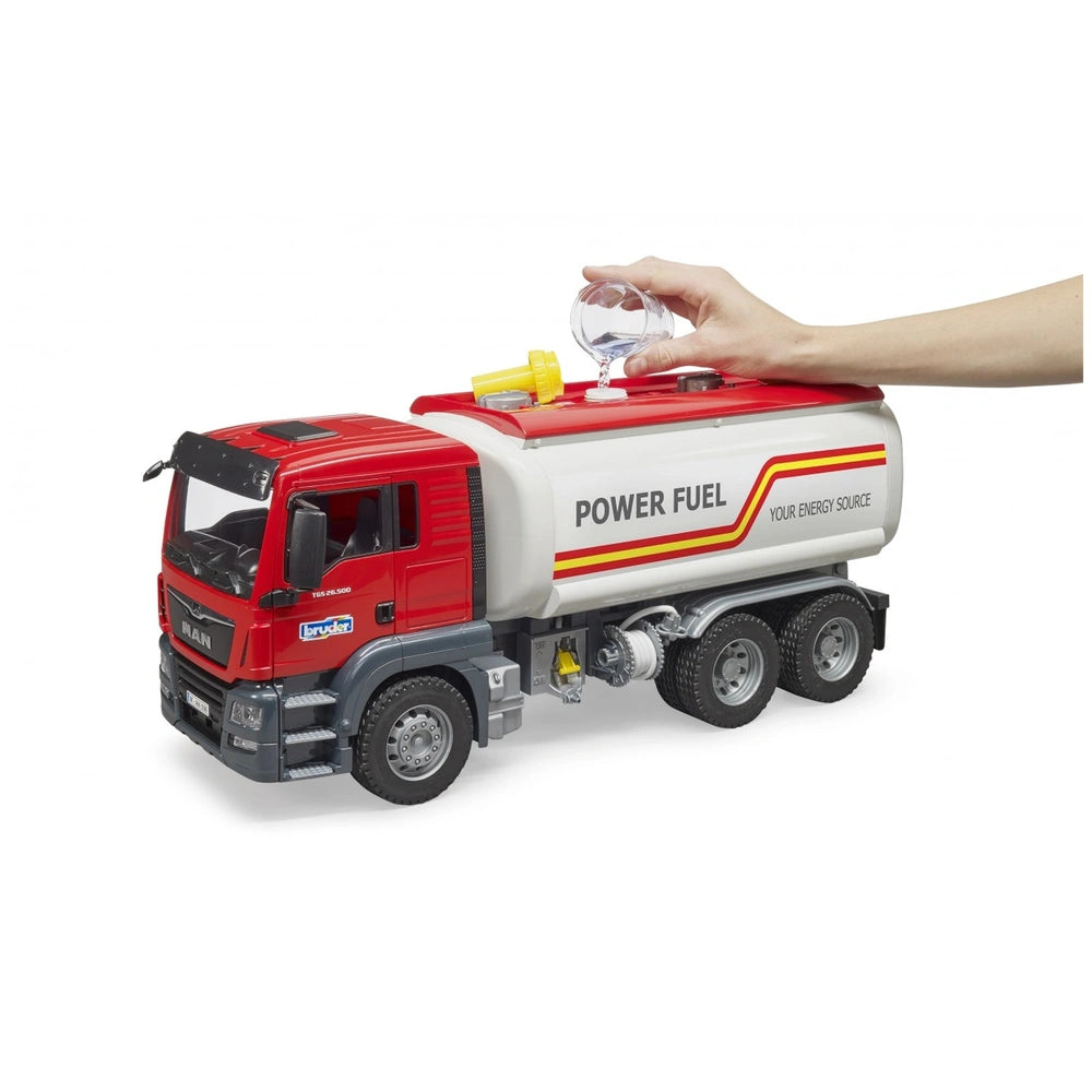 Red and white Bruder MAN TGS Tank Truck toy being filled with water, featuring realistic details and a functional tank.