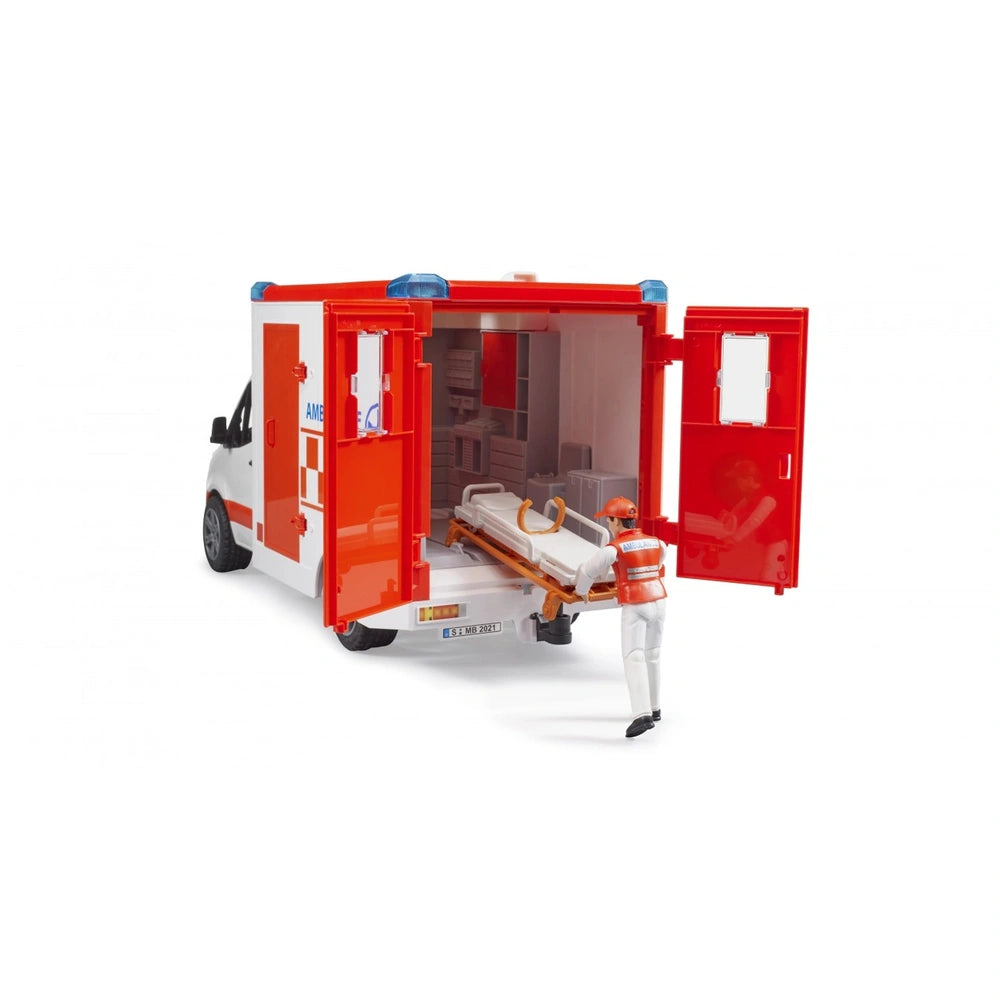 Bruder MB Sprinter toy ambulance with driver figure, red doors open to reveal stretcher inside.