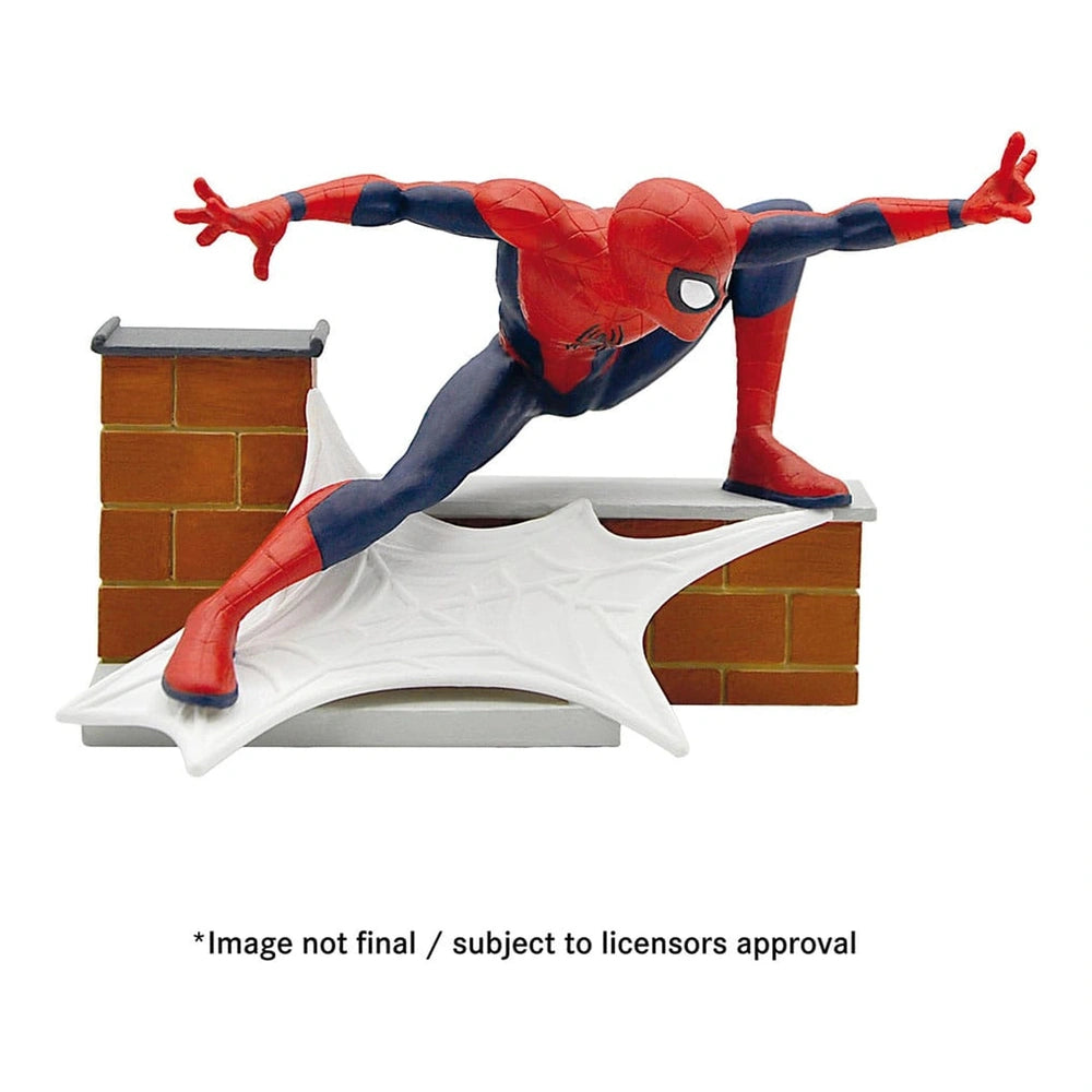 Bullyland Avengers Spider-Man action figure stands on a smooth white platform against a textured red brick wall.