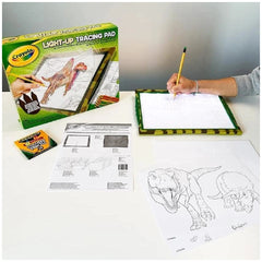 CRAYOLA Light-Up Tracing Pad packaging in green and yellow, featuring a white tracing pad, yellow pencil, and dinosaur drawin