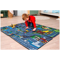 Dickie Playmat features a colorful road map design with vehicles, on light hardwood flooring, as a child plays in red attire.