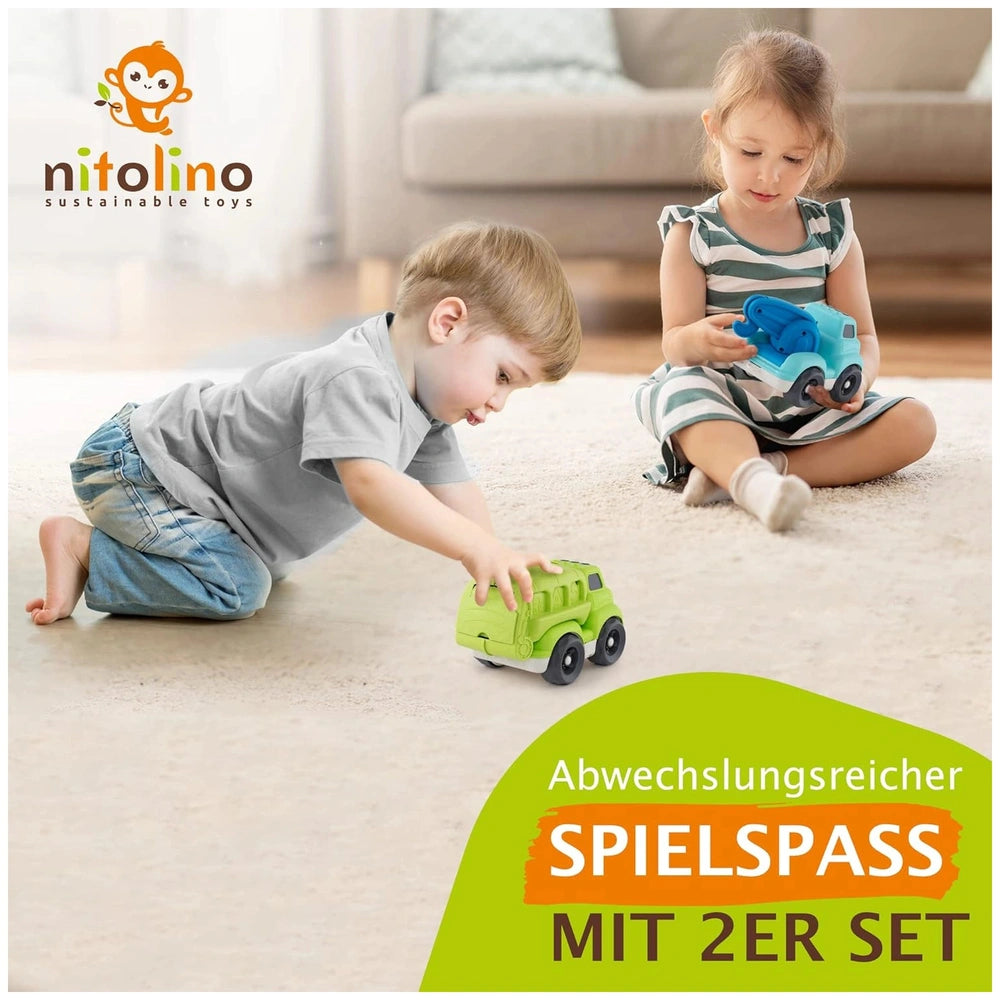 EcoMetropoli sustainable wheat straw vehicle is being played with by two children on a beige carpet, showcasing vibrant color