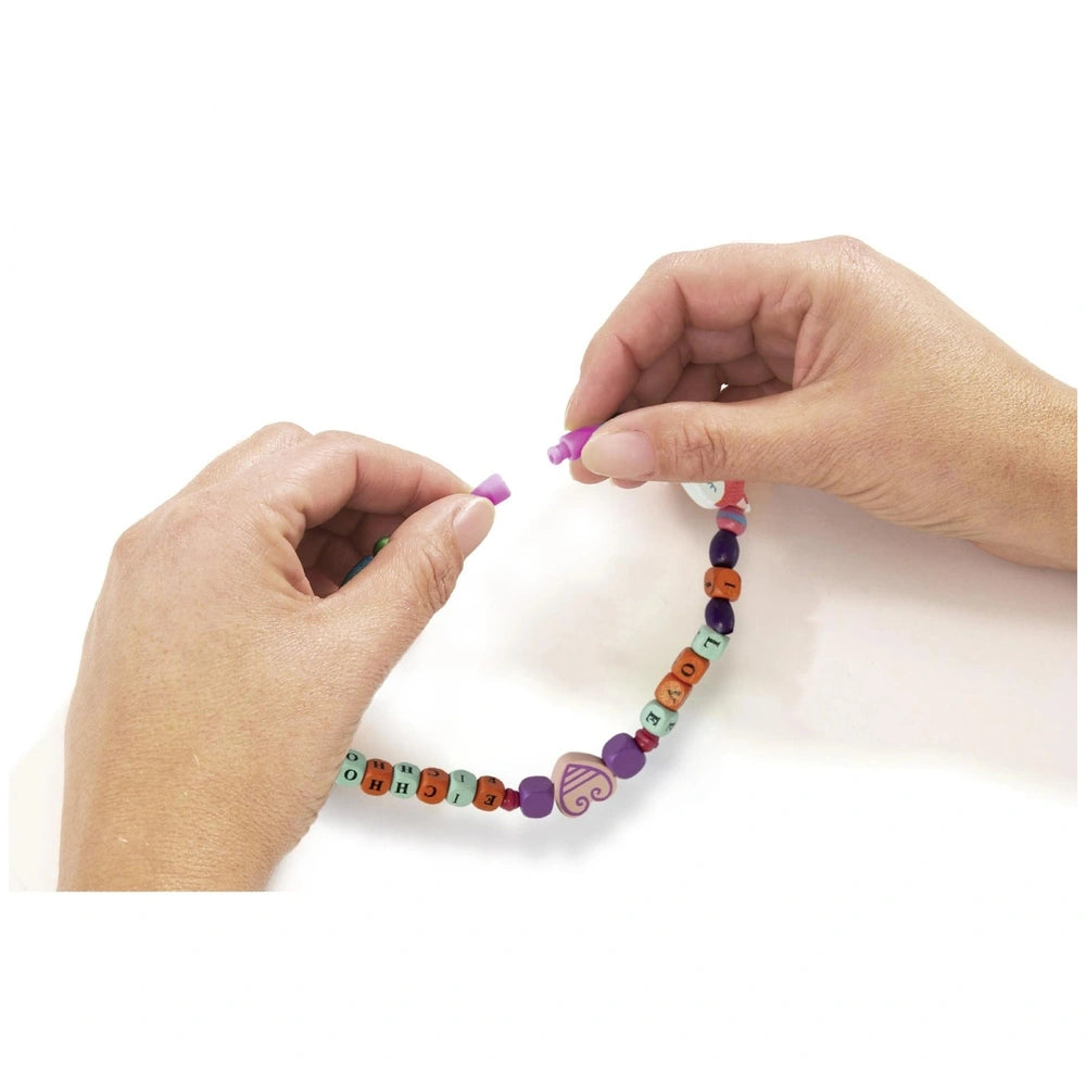 Eichhorn bead set features a close-up of hands crafting a colorful beaded bracelet on a white surface.