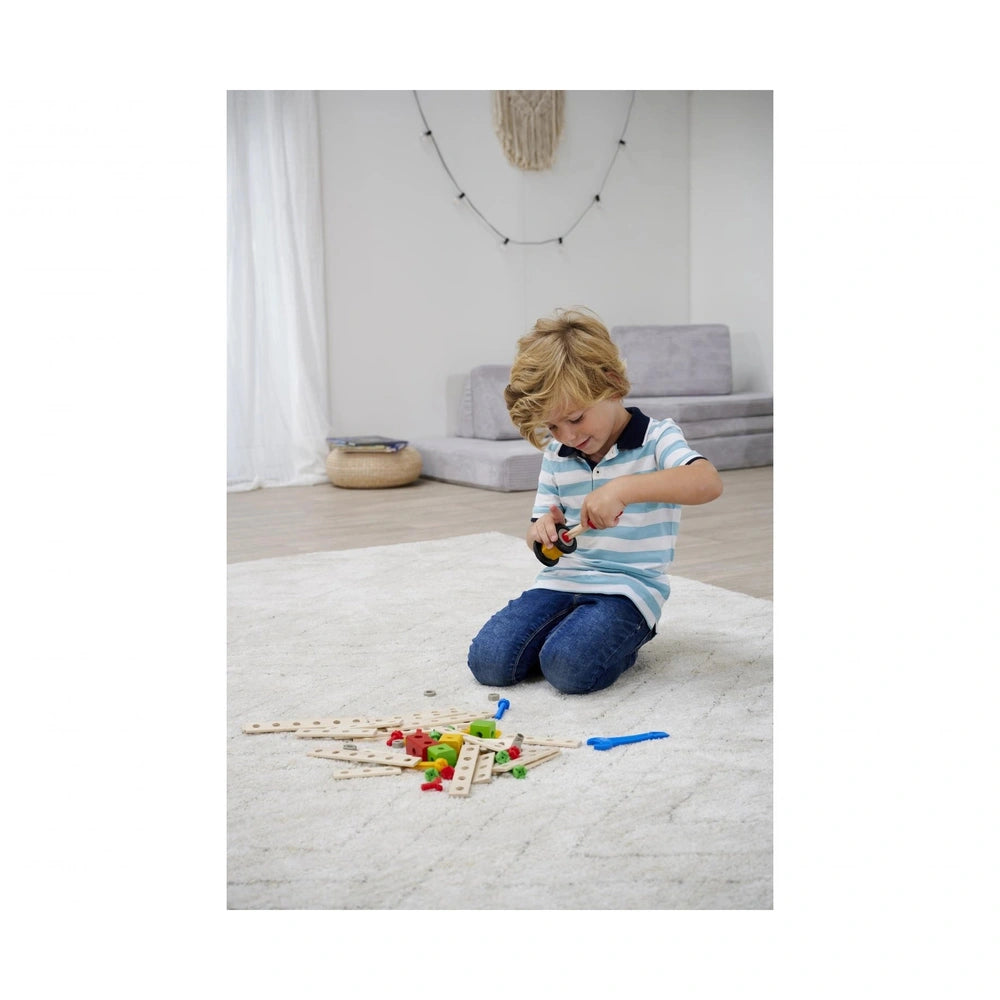 Eichhorn Constructor Expansion Set with 75 colorful pieces is being explored by a focused child on a carpeted floor.