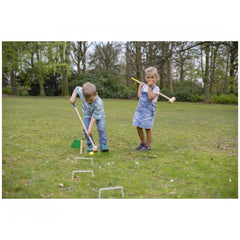 Eichhorn Outdoor Croquet Set with two children playing on grass, one hitting a ball while the other observes.