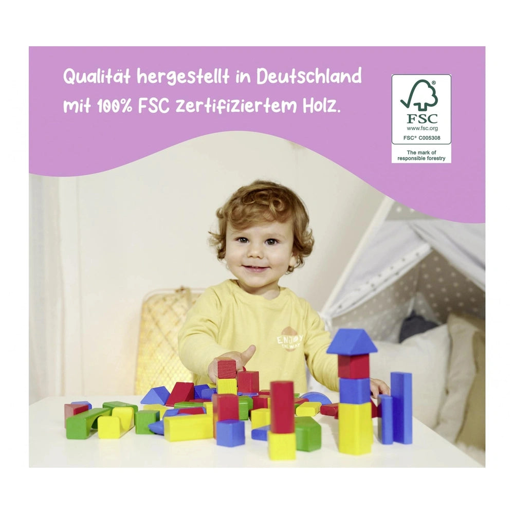 Eichhorn Wooden Colored Blocks - 100 pcs - child playing joyfully with colorful blocks at a table, promoting creativity.