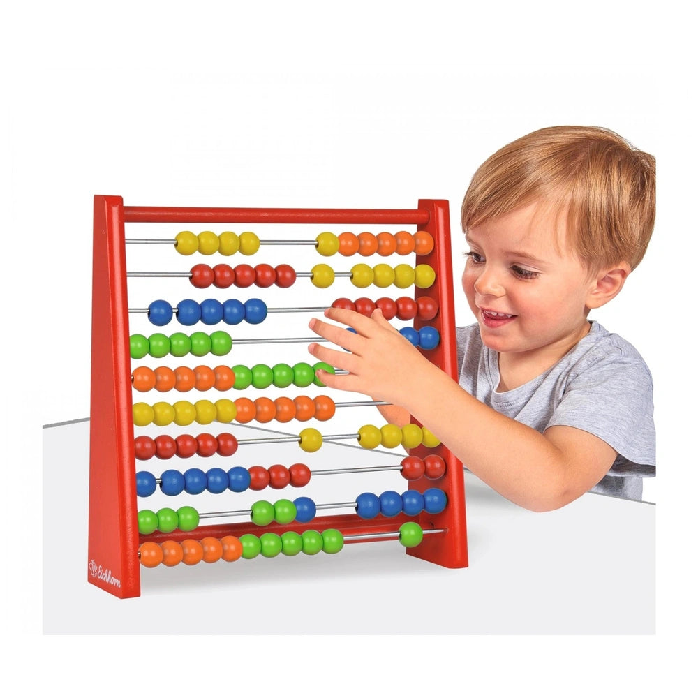 Eichhorn Wooden Slide Rule with colorful beads for educational math activities by a young child.