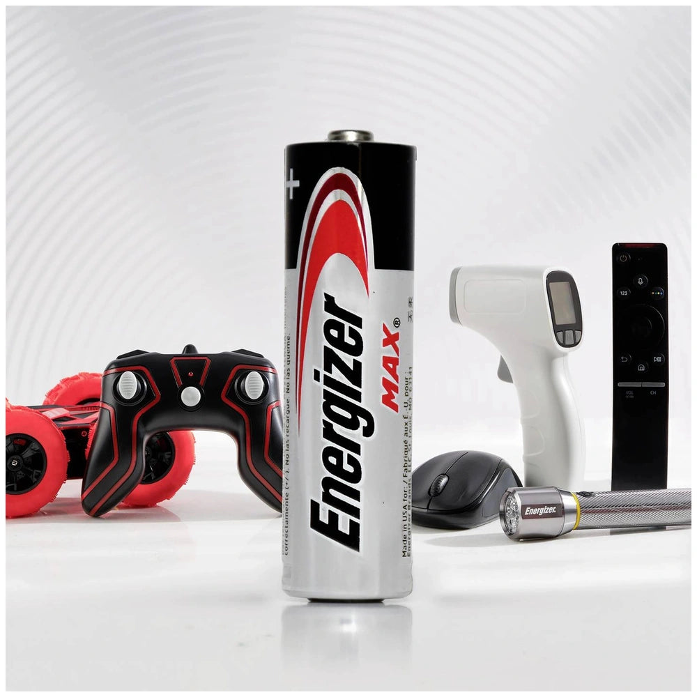 Energizer Max AAA battery in silver and red, surrounded by black remote control, mouse, and silver flashlight.