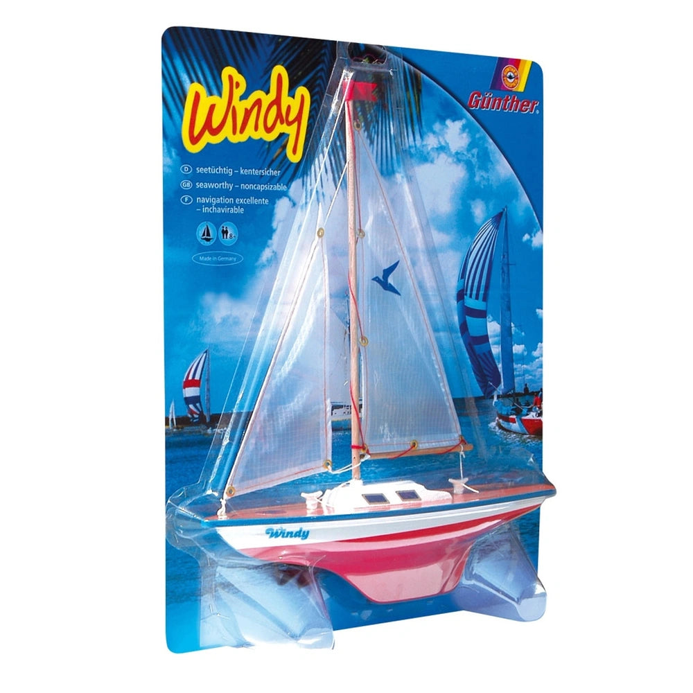 Windy Sailing Boat outdoor play equipment in retail packaging with blue background, featuring a white sailboat with red accen