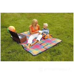 Happy People picnic blanket in multicolored checkered pattern on green grass, with two people enjoying a picnic.