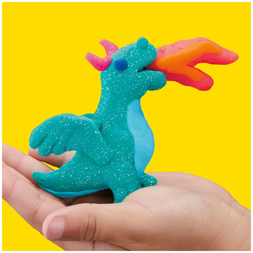 Play-Doh 15 Cans Party Bag featuring a glossy blue dragon figurine with a pink horn and red tail in a close-up view.