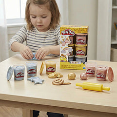 Play Doh Metallics Compound Collection displayed on a light wooden table with a child in a striped shirt holding a blue star-