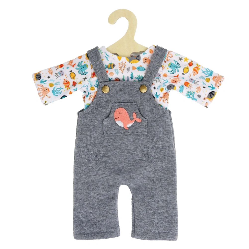 Heless dungarees with a colorful whale pattern bib, gray textile overalls, and pink fish-shaped pocket design.