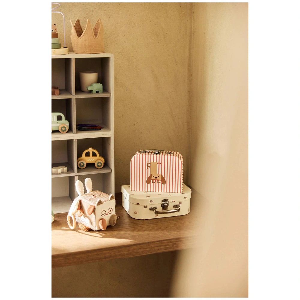 Jollein Activity Cube featuring a small brown and white animal figure atop a white suitcase with red stripes on a light wood 