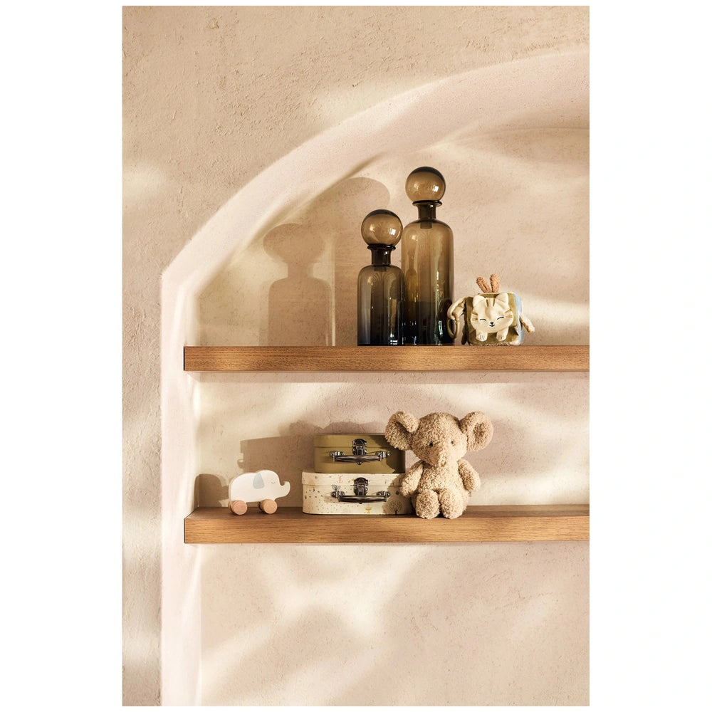Jollein Activity Cube Tiny Park with a brown shelf, glass bottles, a fabric teddy bear, and a white toy car in a lifestyle se