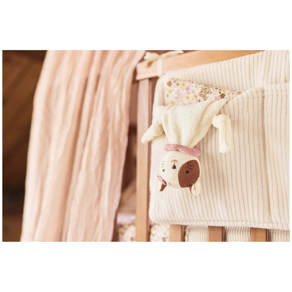 Jollein pacifier cloth Jill displayed on a wooden crib with a pink and white canopy and a plush stuffed animal.